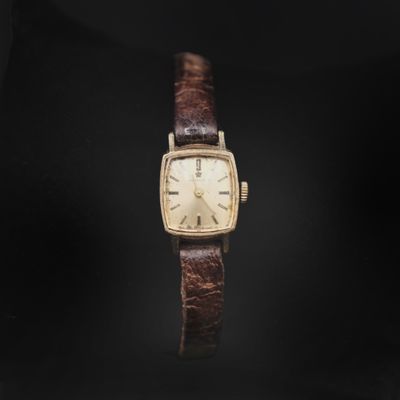 a close up of a watch on a black background