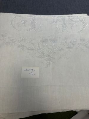 a piece of white linen with a design on it