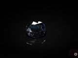a dark blue diamond on a black surface