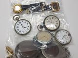 a bag of assorted pocket watches on a table