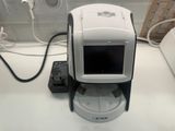 a white and black camera sitting on top of a counter