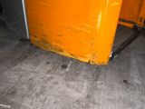 a yellow refrigerator sitting in the corner of a room