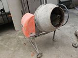 a cement mixer that is sitting in a garage