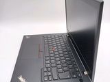 a laptop with a black keyboard on a white surface