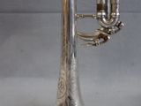 a silver trumpet that is sitting on a table