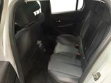 the back seats of a car with a remote control in it