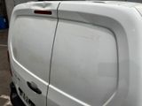 a white van parked in a parking lot next to a building