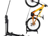 the bike stand is holding two bikes on it ' s sides