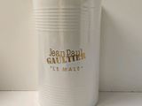 a white canister with the word jean paul gauttier on it
