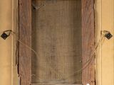 an old picture of a wooden frame with a tag on it