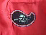 red jacket with a black and orange logo on the chest