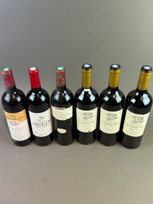 six bottles of wine are lined up in a row on a table