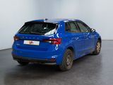 the rear end of a blue car parked in a room