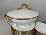 a stack of plates and a bowl on a table