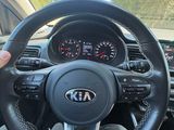 the steering wheel of a car with a person holding a steering wheel