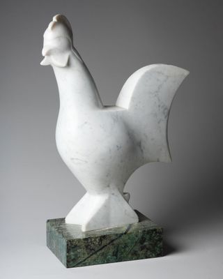 sculpture of a white chicken on a green marble base