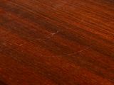 a close up of a wooden table with a clock on it