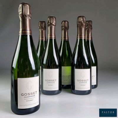 six bottles of wine are lined up in a row on a table