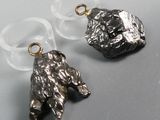 two pieces of silver and clear glass with a bear on it