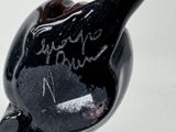 a black bird that is sitting on top of a table