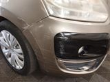 a car that has been dented and is parked in a garage