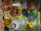 a green tray with a lot of glass items on it