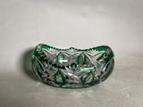 an image of a green glass bowl sitting on a white surface