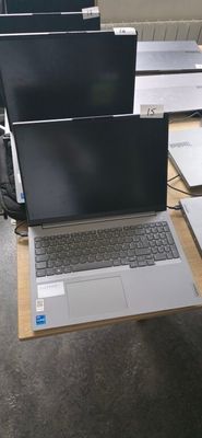 many laptops sitting on a table in a room