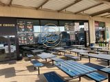 tables and benches are lined up outside of a fast food restaurant