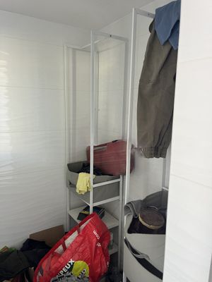 a small room with a shelf and some luggage in it
