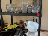 a shelf that has a bunch of dishes and pans on it
