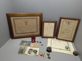 three framed photographs of military memorabilia on display on a table