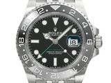 a close up of a wrist watch with a black dial