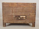 an old wooden chest with two drawers on top of it