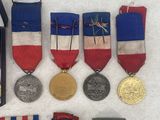 many medals and medals displayed on a white surface