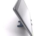 a tablet computer sitting on a stand on a white surface