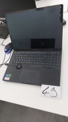 a laptop computer sitting on a desk next to a keyboard