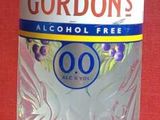 a bottle of gordon ' s gin on a red table