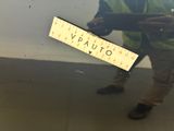 a man that is holding a ruler in front of a wall