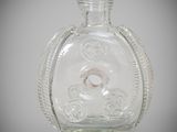 a clear glass bottle with a ring inside of it