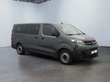 the grey van is parked in the empty room of the building
