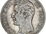 gros plan d'une pièce de monnaie sur laquelle figure un visage de femme