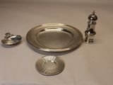 une assiette en argent et un bougeoir en argent posés sur une table
