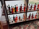Des bouteilles d'alcool sont alignées sur une étagère dans une pièce