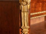 a marble top desk with a gold lion head on top of it