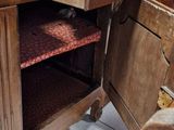 a wooden table with a bunch of suitcases on top of it