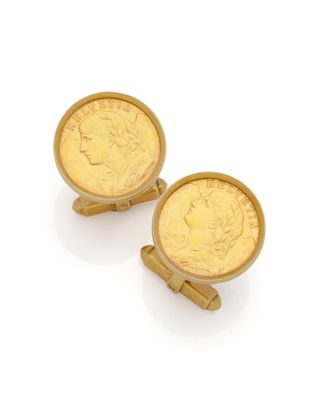 a pair of gold cufflinks with a coin in the middle