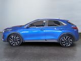 the blue suv is parked in a room with a white wall