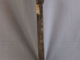 a wooden pole that is leaning up against a white backdrop
