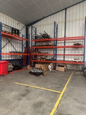 a large warehouse with lots of shelves and bins in it